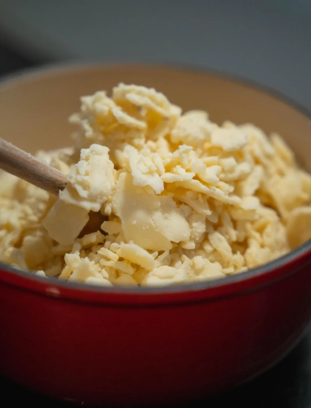 Preparing the fondue: grated cheese in the pot