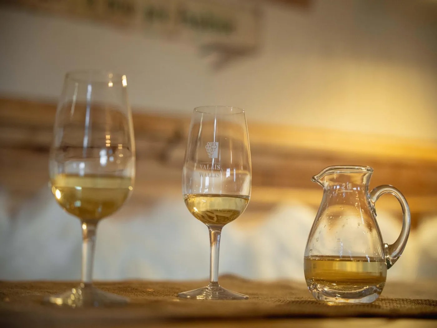 Glasses of white wine and a jug engraved Valais