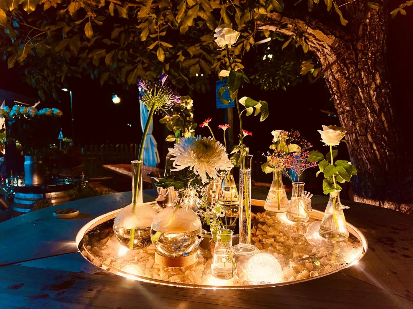 Illuminated floral table centrepiece during an evening